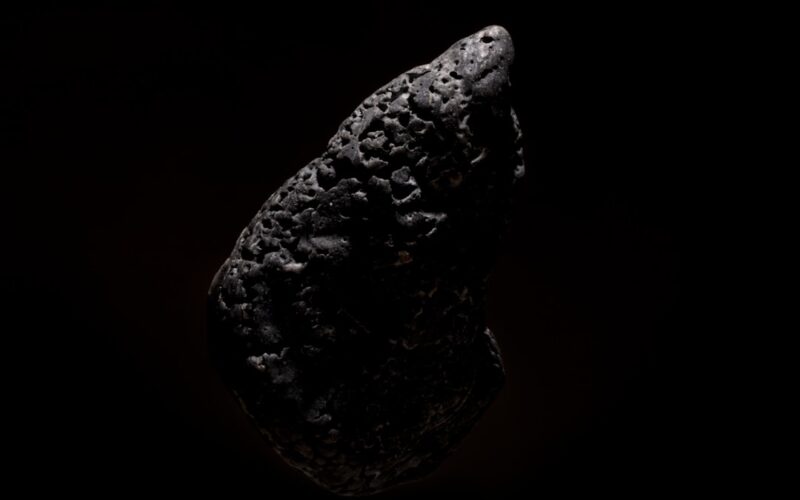a piece of black rock on a black background
