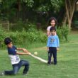 2 boys playing golf during daytime
