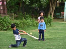 2 boys playing golf during daytime