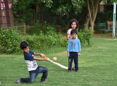 2 boys playing golf during daytime