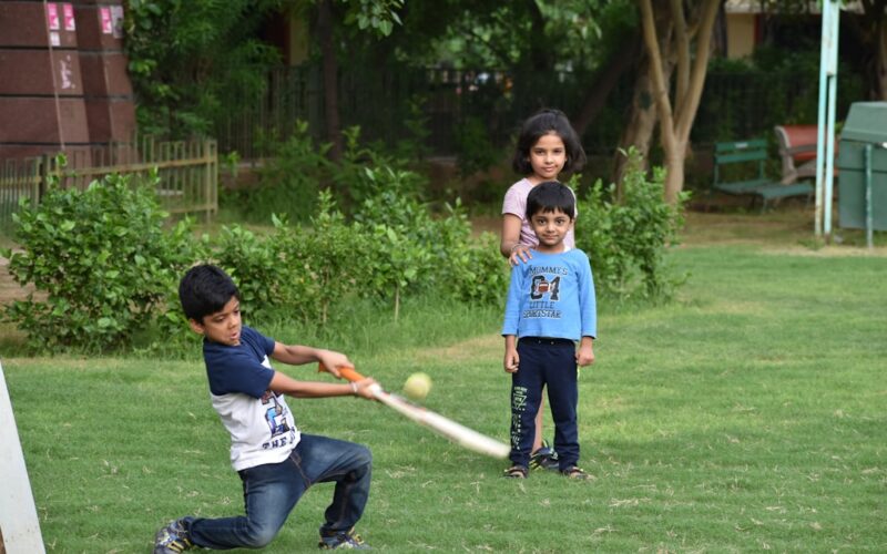 2 boys playing golf during daytime