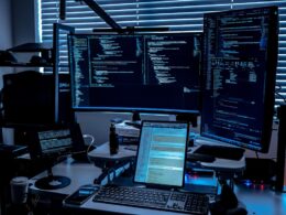 a desk with several monitors