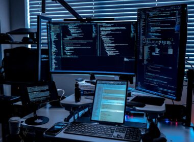 a desk with several monitors