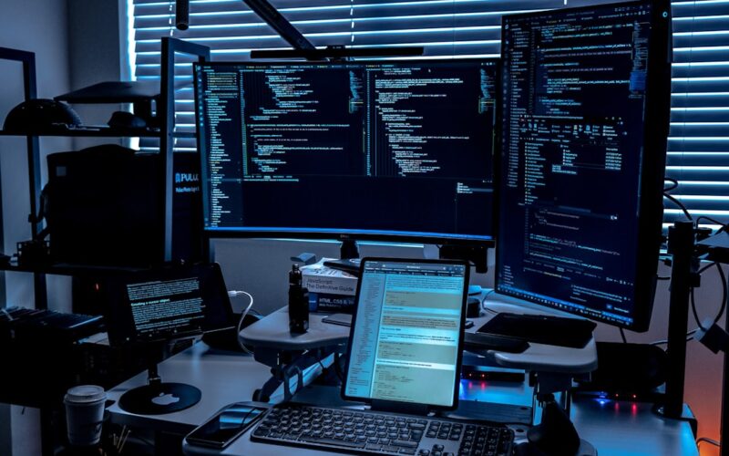 a desk with several monitors