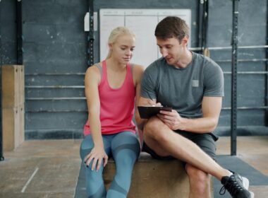 Man and woman looking at tablet in gym