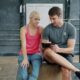 Man and woman looking at tablet in gym