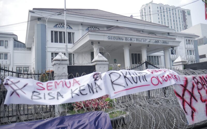 a white building with a banner in front of it