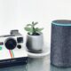 polaroid land camera beside Amazon Echo