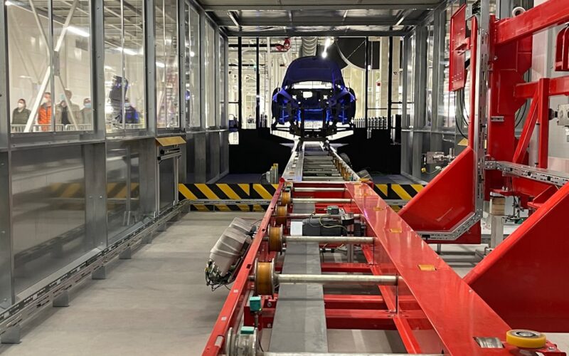 a car being built in a large factory