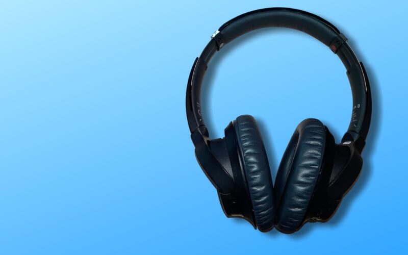 black corded headphones on blue background