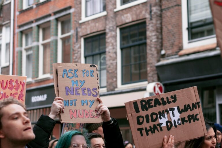 woman holding blue and white wooden signage