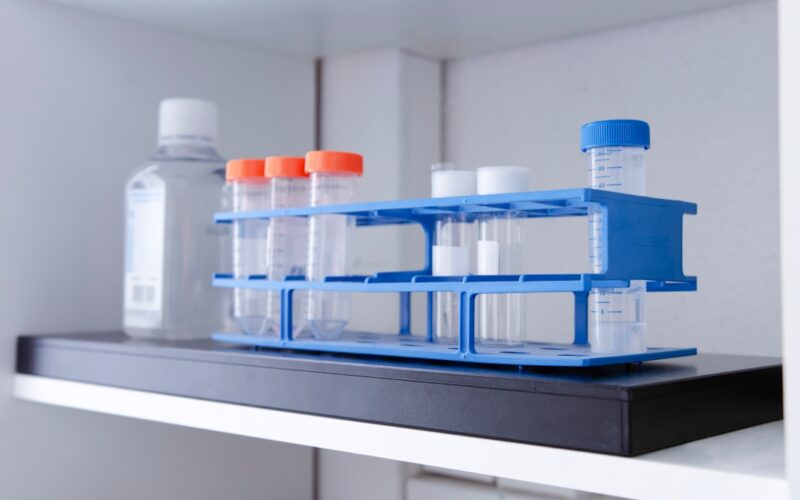 Test tubes and bottle on a shelf