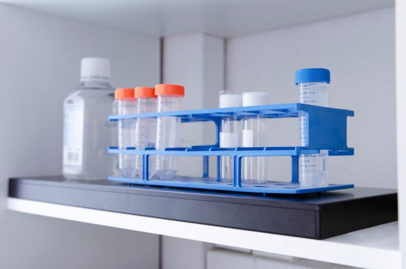 Test tubes and bottle on a shelf