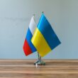 Russian and ukrainian flags on a table