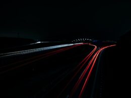 a long exposure photo of a highway at night