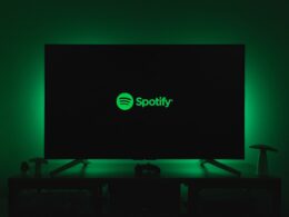 the spotify logo is lit up on a flat screen tv