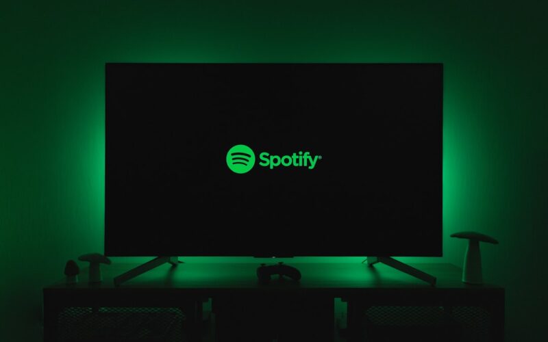 the spotify logo is lit up on a flat screen tv