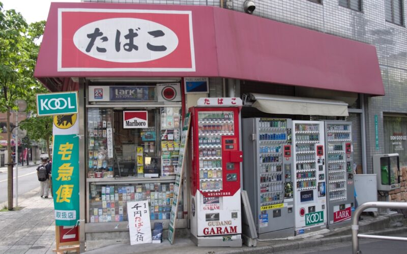 A small convenience store with cigarette and drink vending machines.