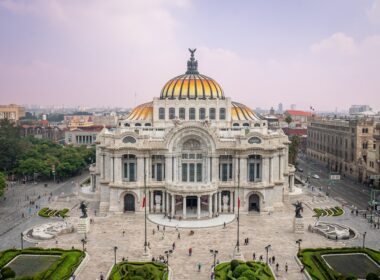 Grand ornate building with golden dome and city background