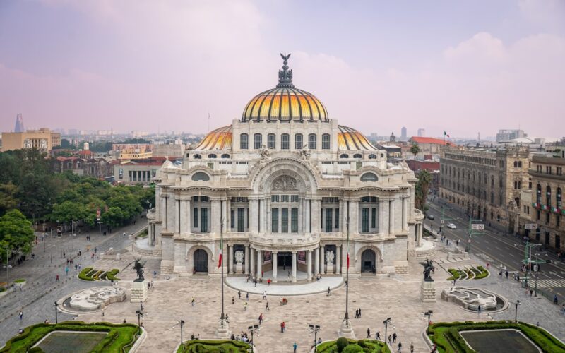 Grand ornate building with golden dome and city background