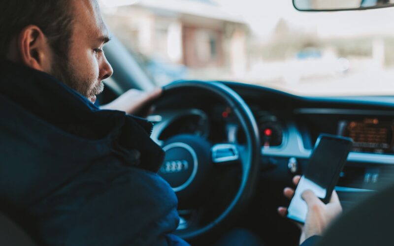 man holding black smartphone