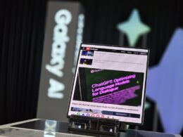 A laptop computer sitting on top of a glass table