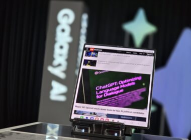 A laptop computer sitting on top of a glass table
