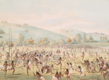 Native americans playing a game on a grassy field.