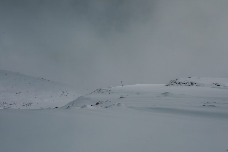 a person skiing down a snow covered slope