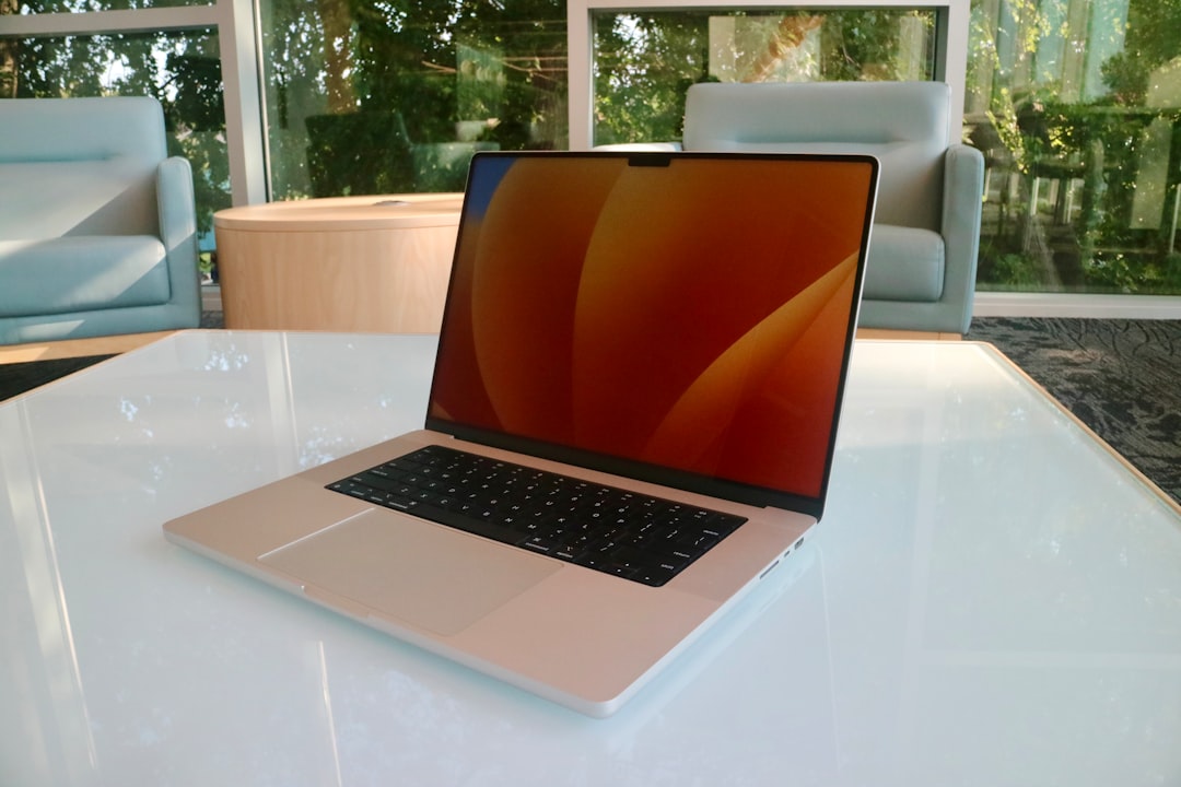 a laptop computer sitting on top of a white table
