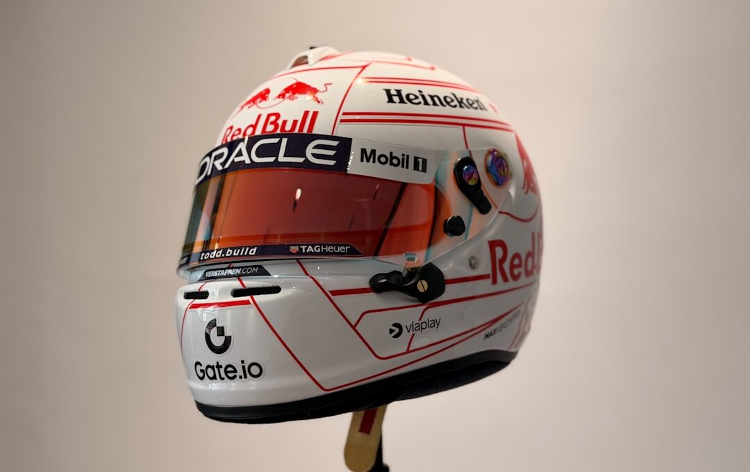 White racing helmet with red accents and sponsor logos