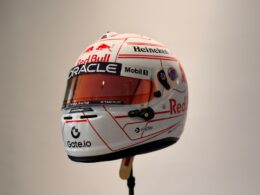 White racing helmet with red accents and sponsor logos