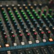 a close up of a sound mixing console