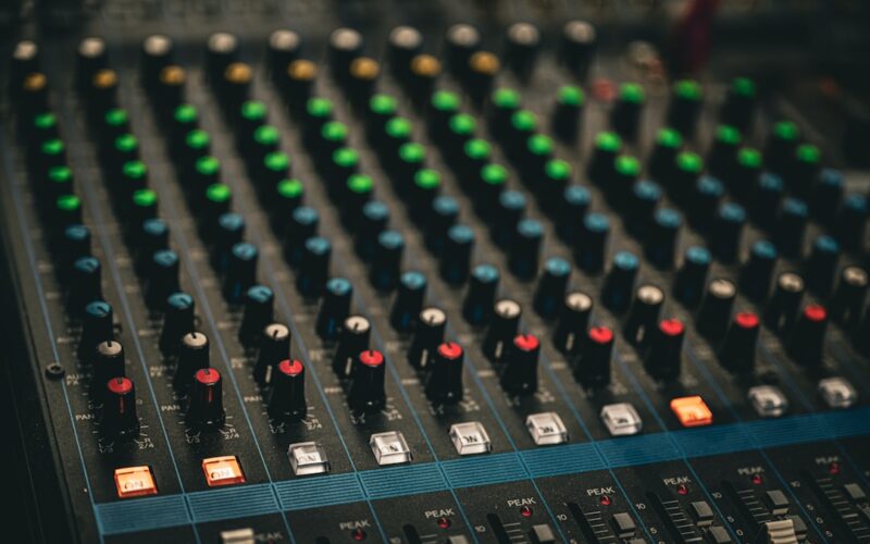 a close up of a sound mixing console
