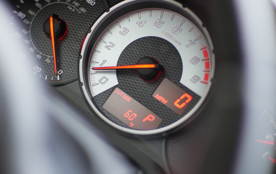 black and gray speedometer at 0