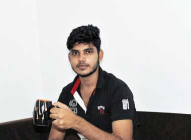 a man sitting on a couch holding a cup