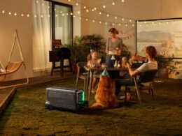 a group of people sitting around a table with a dog
