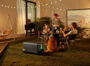 a group of people sitting around a table with a dog