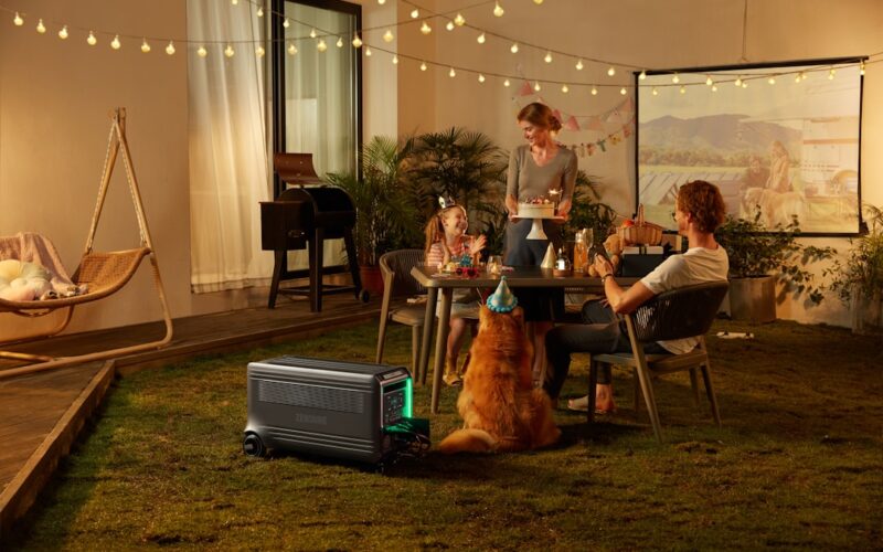 a group of people sitting around a table with a dog
