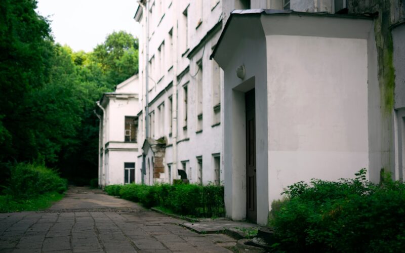 a white building with trees and bushes
