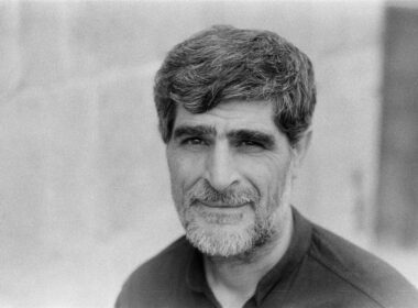 man in black collared shirt