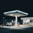 a car is parked at a gas station at night