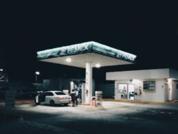 a car is parked at a gas station at night