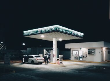a car is parked at a gas station at night