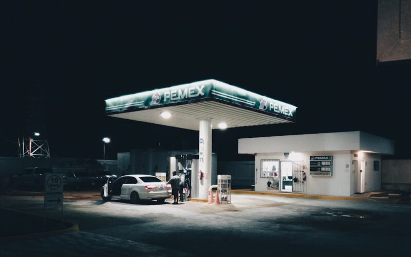 a car is parked at a gas station at night
