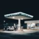 a car is parked at a gas station at night