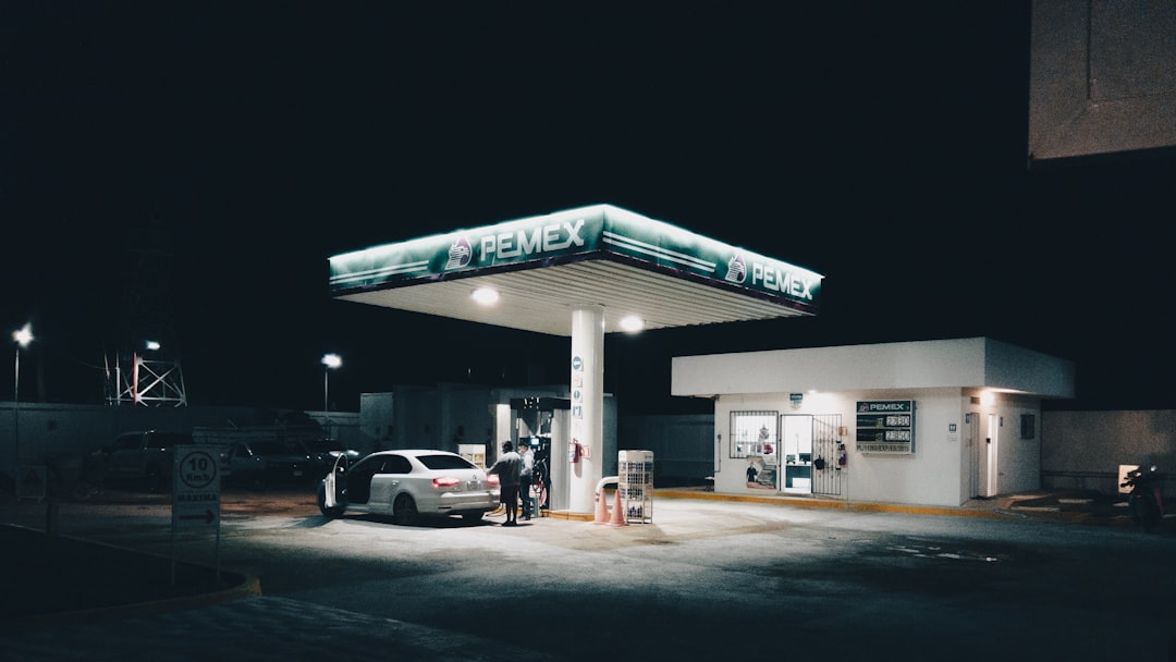 a car is parked at a gas station at night