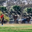 a man playing a game of cricket in a park