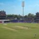 Cricket stadium with players on the field