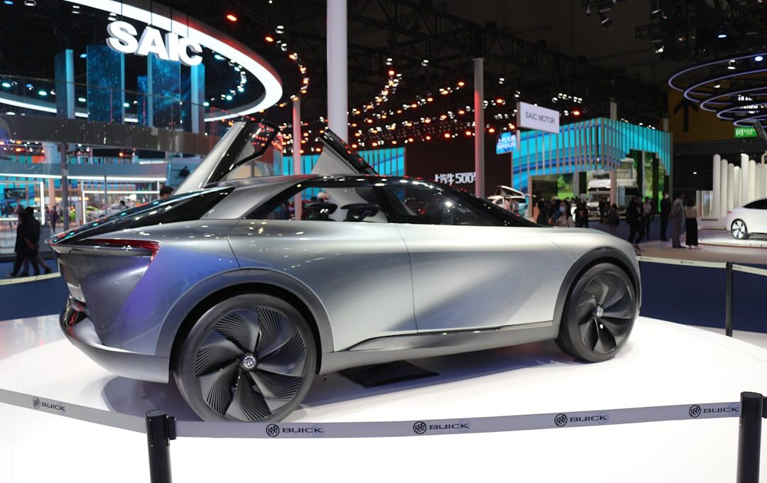 a silver car is on display at a show